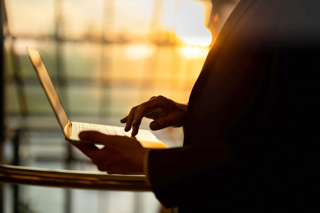 Woman with computer in sunlight